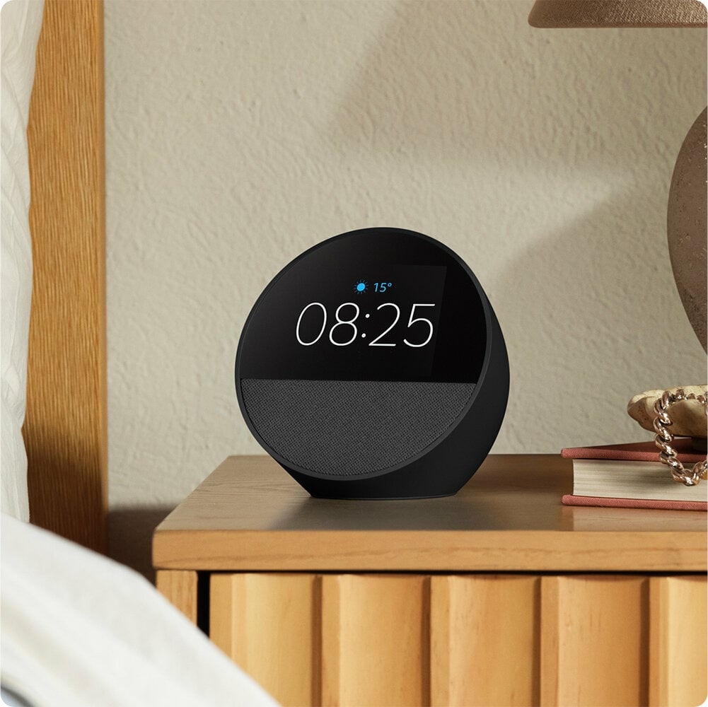 Amazon Echo Spot (2024) Black on a bedside table showing alarm clock